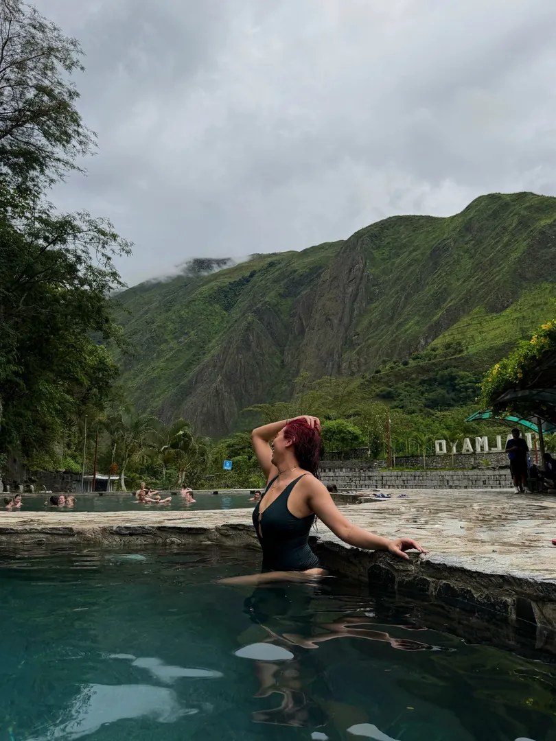 Cocalmayo hot springs in Santa Teresa with a sign and the range behind
