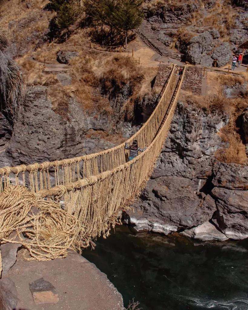 Traveler crossing the Inca Q'eswachaka Bridge